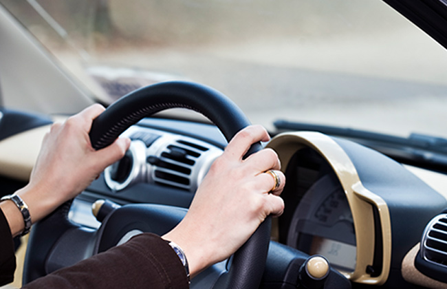 Hand on steering wheel